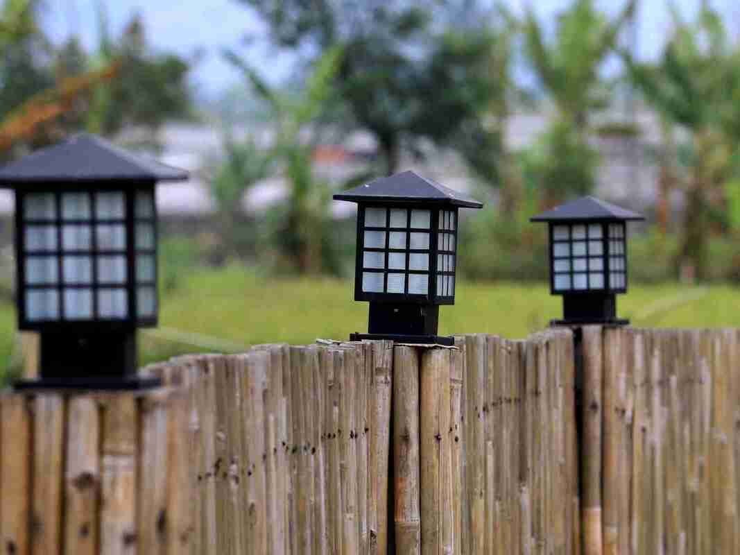 outdoor lighting on a garden fence